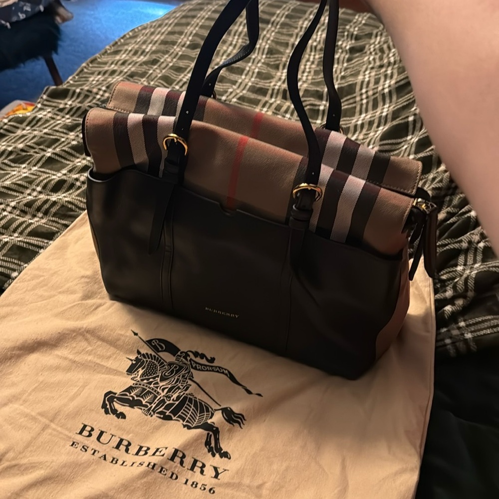 Burberry diaper bag. Never used. Comes with changing pad and dust bag.